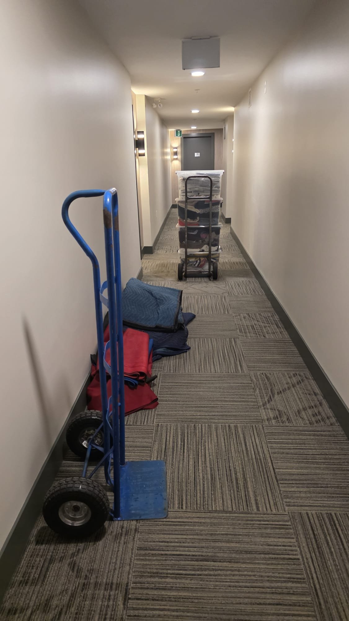 Always Best Moving Vancouver crew hauling items out on a dolly during a Vancouver clear-out