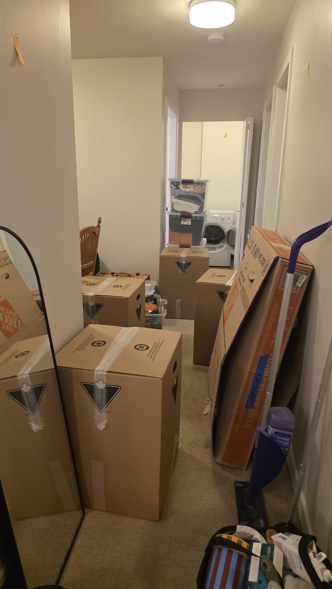Always Best Moving crew wheeling wrapped office equipment through a Vancouver building