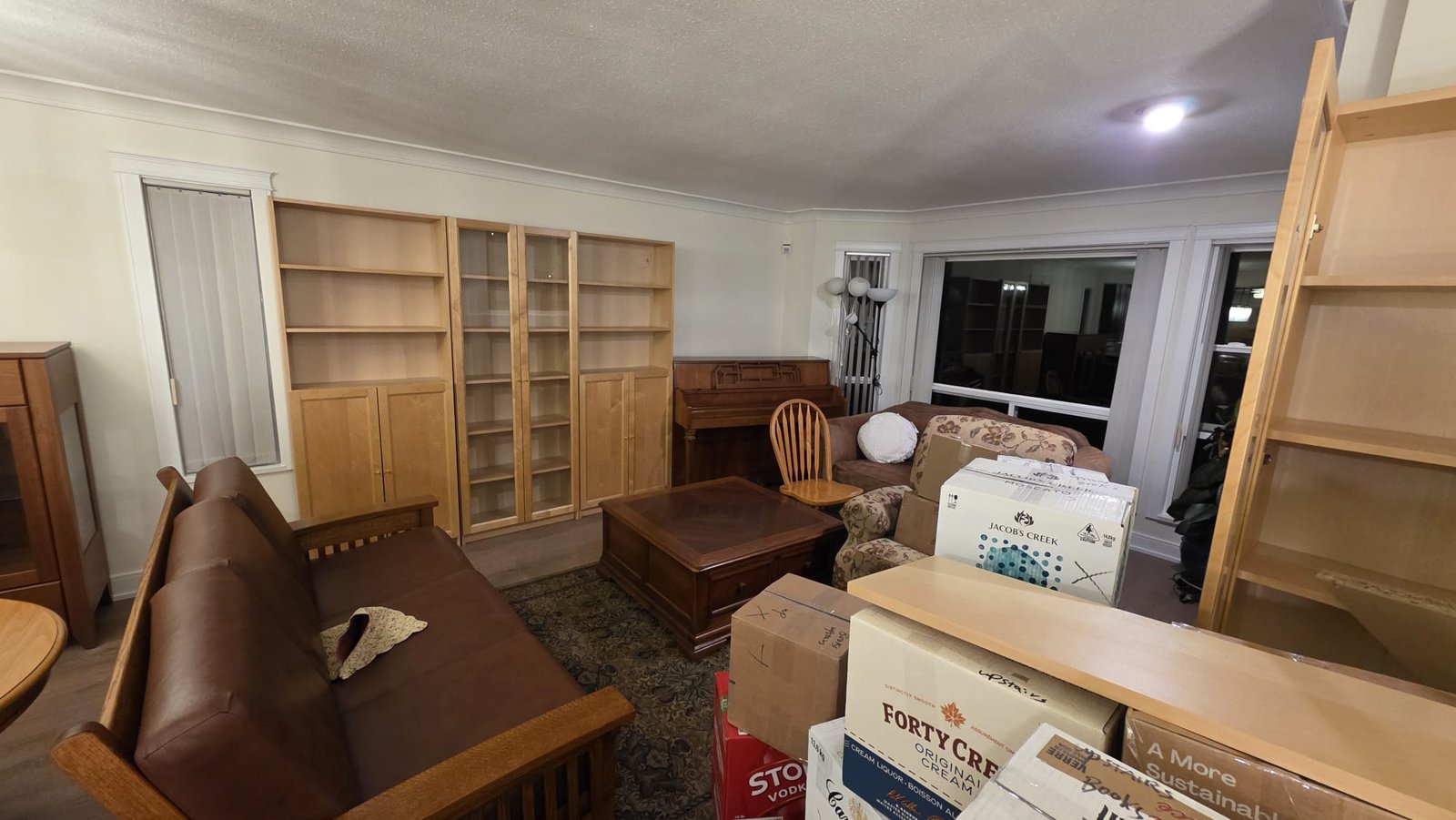 Living room packed for a Vancouver condo move by Always Best Moving Vancouver, boxes labelled and furniture staged